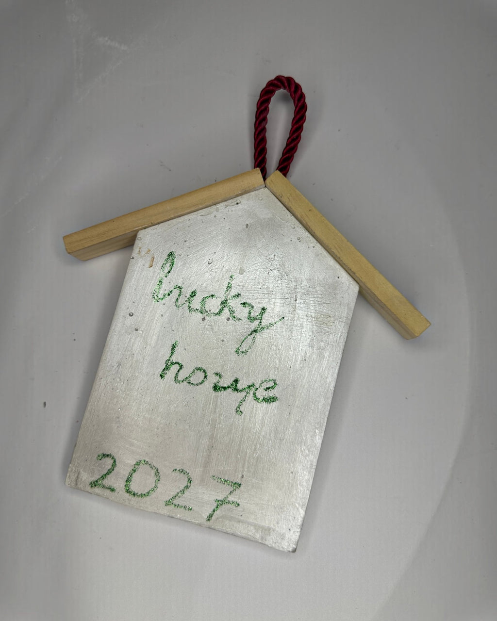 Μπροστινή όψη λευκού κρεμαστού γουριού Lucky Home 2027 με φυσικές ξύλινες λεπτομέρειες