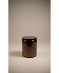 ELAIOPHOS amber glass candle with black lid, featuring shimmering gold flecks in wax for a luxurious ambiance.